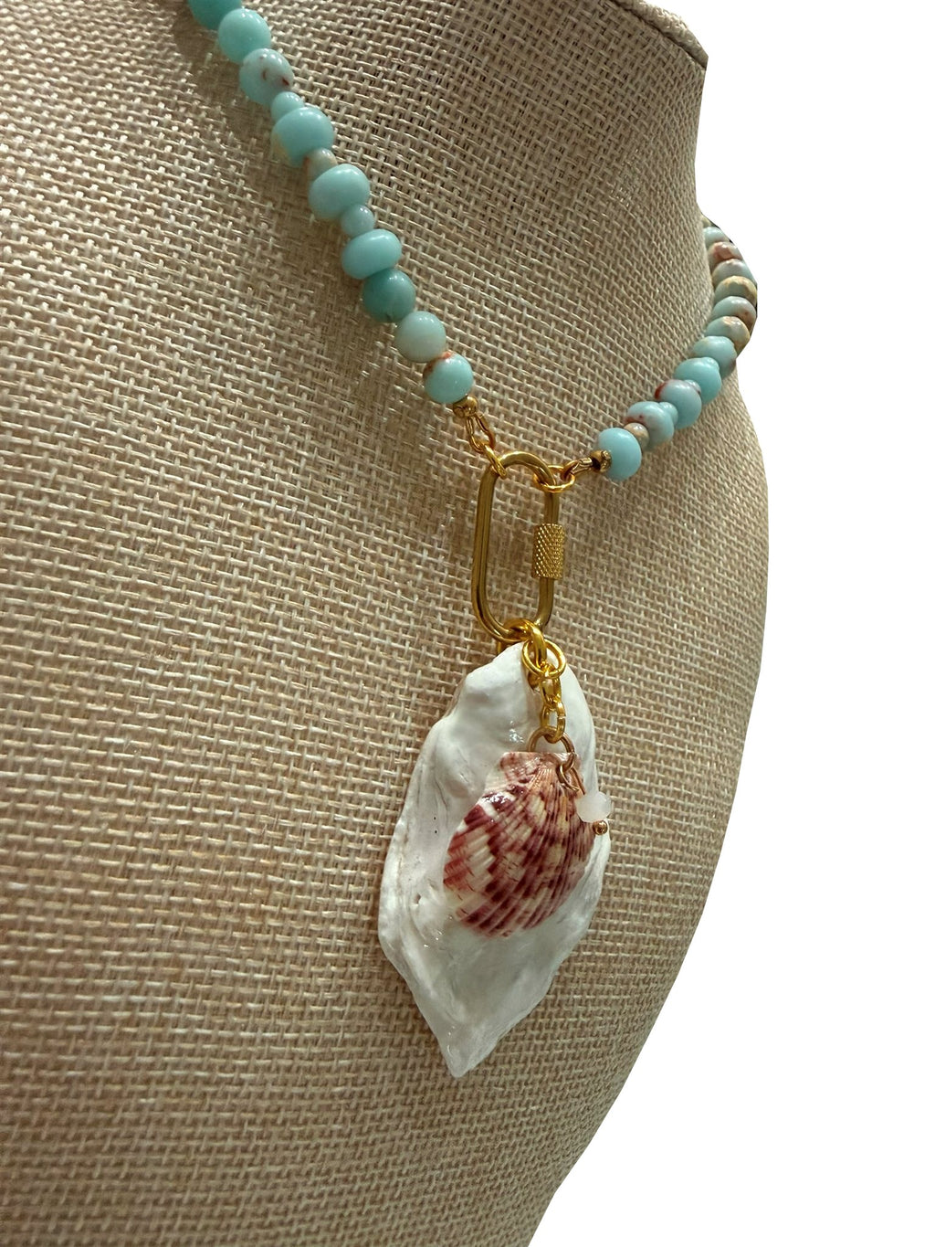 Galatea necklace on a bust form, side view of the white oyster shell and scallop